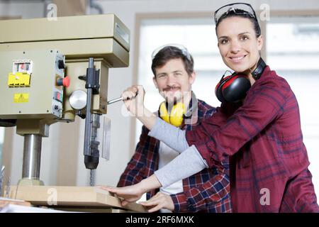 female apprentice learning how to cut wood Stock Photo