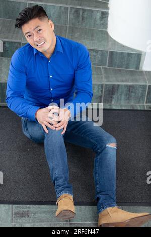 mature man lying on staircase after slip and fall accident Stock Photo
