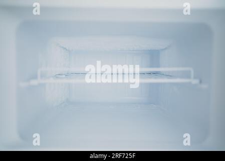Empty open freezer in the refrigerator. Stock Photo