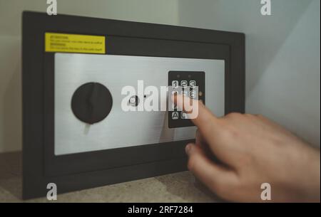 Man's hand opening small safe. Stock Photo