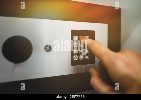 Man's hand opening small safe. Stock Photo