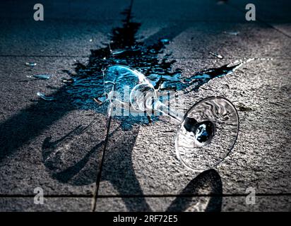Shattered champagne glass spilling blue liquid Stock Photo