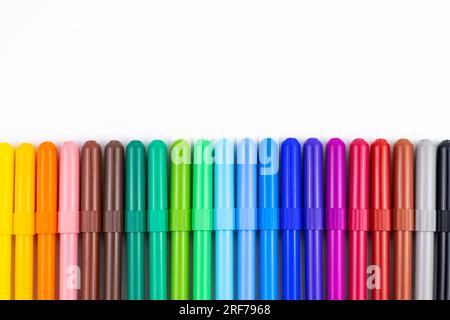 Multi-colored felt tip pens on white background. Back to school colorful banner. Copy space. Stock Photo