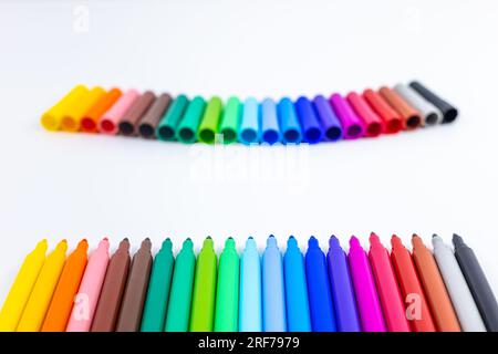 Multi-colored felt tip pens on white background. Back to school colorful banner. Copy space. Stock Photo