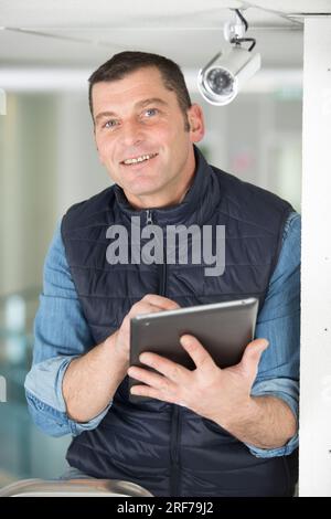 professional cctv technician working with tablet Stock Photo
