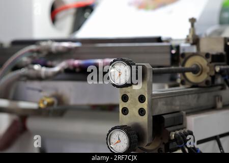 Industrial machine with lobe knobs for analog position indicators. Selective focus. Stock Photo