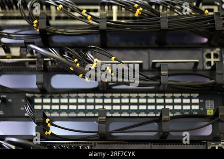 Server rack with metal horizontal cable managers close up. Selective focus. Stock Photo