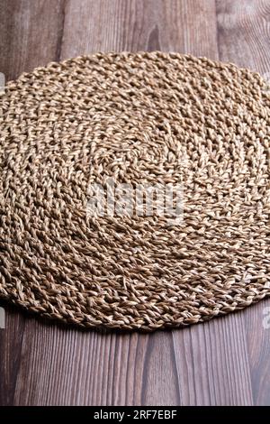 photo of a woven straw napkin on a table, side view, top view Stock Photo