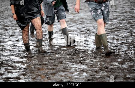 Wacken, Germany. 01st Aug, 2023. White underpants with the inscription  WOA23 hang under a tent roof on the festival grounds, which are soaked  and muddy from the rain. The Wacken Open-Air (WOA)