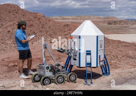 A judge scores the Binghamton University Mars Rover working on the Mars Lander in the University Rover Challenge.  Mars Desert Research Station, Utah. Stock Photo