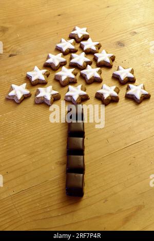 Christmas, Pastries, Decorations And Symbols: Dominos And Cinnamon Stars Arranged In The Shape Of A Tree Stock Photo