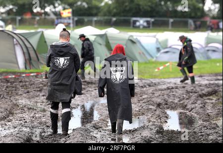 Wacken, Germany. 01st Aug, 2023. White underpants with the inscription  WOA23 hang under a tent roof on the festival grounds, which are soaked  and muddy from the rain. The Wacken Open-Air (WOA)