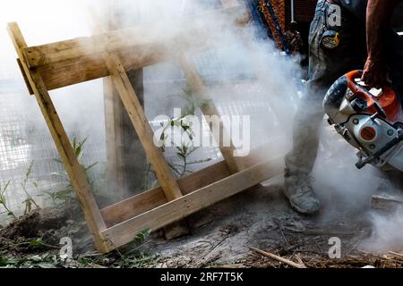 Man cutting concrete with saw Stock Photo