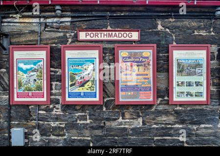 17 April 2003: Porthmadog, Gwynedd, Wales - Posters on the wall at Harbour Station, Porthmadog, on the Welsh Highland and Ffestiniog lines.. Stock Photo