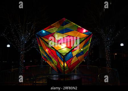 A multicoloured cube at night in Canary Wharf - part of an arts festival Stock Photo