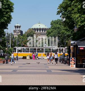 Sveta Nedelya Cathedral Church (Eastern Orthodox) with a yellow Tram aka Streetcar aka Trolley, city of Sofia, Bulgaria. August 01, 2023. Stock Photo