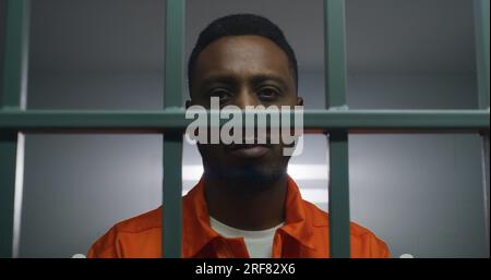 African American Prisoner In Handcuffs Behind Prison Bars Stock Photo ...