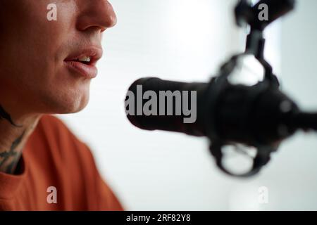 Radio host speaking in microphone when recording show Stock Photo