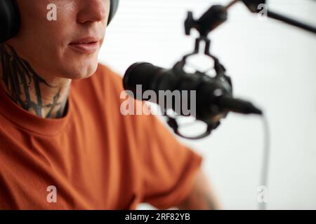 Cropped image of radio host speaking in microphone Stock Photo