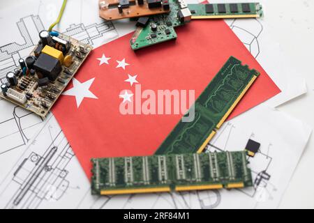 Republic of China flag on a red painted PC motherboard with some processors on it. Concept for supremacy in global microchip and semiconductor Stock Photo