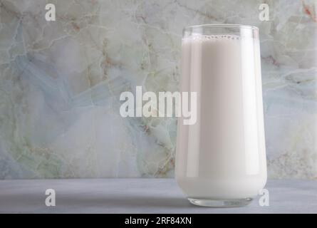 A glass of milk on a blue table on a marble background,copy space Stock Photo