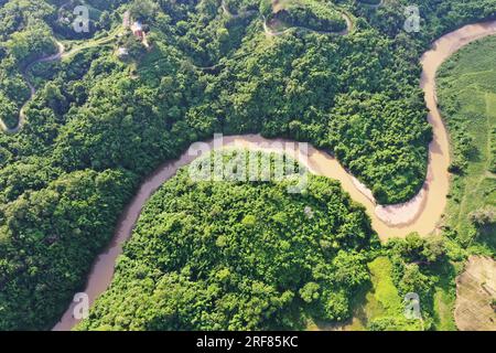 Khagrachhari, Bangladesh - July 23, 2023: The crooked Chengi River flows through the hills of Khagrachari district in Bangladesh. Stock Photo