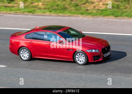 2016 Jaguar Xf R-Sport D Auto 2.0D I4 163 Auto Start/Stop Red Car Saloon Diesel 1999 cc travelling at speed on the M6 motorway in Greater Manchester, UK Stock Photo