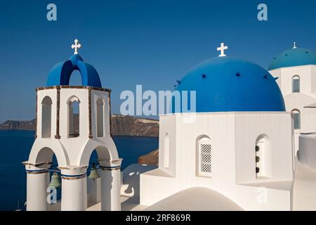 White churches with blue dome - Agios Spiridonas (St Spyridon) and Church of Anastasis (Resurrection), Ia (Oia), Santorini, Greece Stock Photo