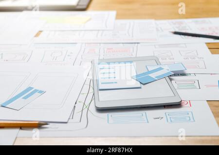 Top view of Creative flat lay UX designer working space and office supplies. Smartphone application layout prototype project. Stock Photo