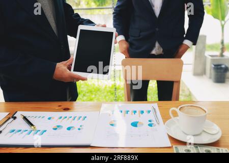 Business man holding and shows digital tablet with blank screen. Stock Photo