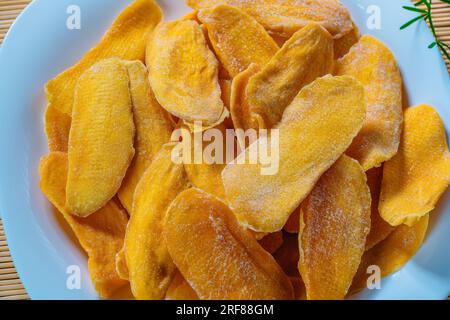 Dried mango on white plate close-up Stock Photo
