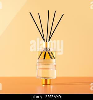 The concept of a home comfort, decoration and aromatherapy. Scented arroma diffuser with essential oil on the beige background. Creative trendy image Stock Photo