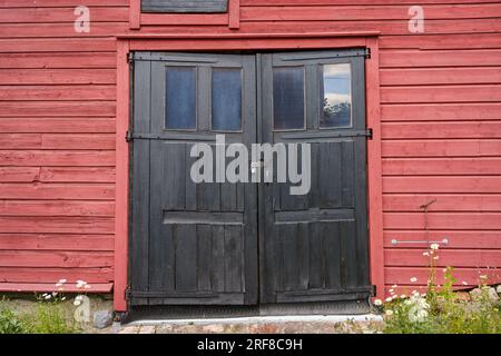 Old black wooden double doors in historical building in Porvoo, Finland. Stock Photo