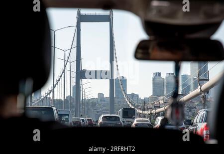 Traveling west in a taxi across the Bosphorus Bridge which connects the Asian side of Istanbul with the western side. Stock Photo