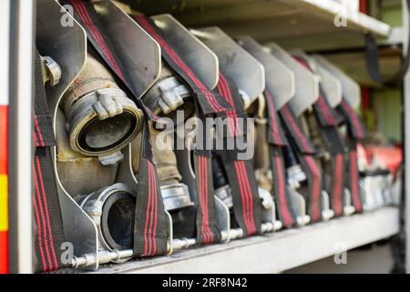 Fire truck equipment. Compartment of the rolled up fire hoses on a fire engine Stock Photo