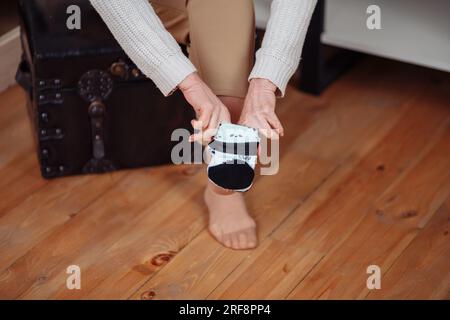 Close up of the hands of an elderly woman knitting sock. High quality photo Stock Photo