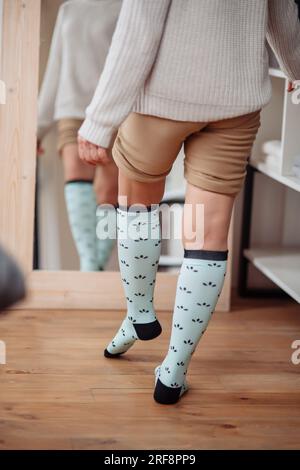 Close up of the hands of an elderly woman knitting sock. High quality photo Stock Photo