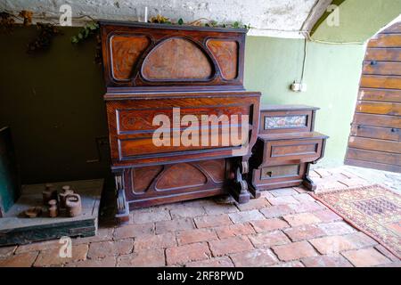 Old retro piano placed in dark gloomy rooms. Stock Photo