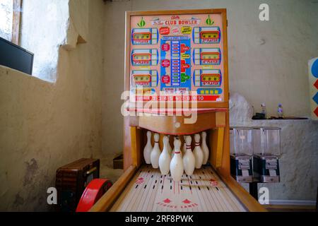 Pakruojis, Lithuania. July 7 , 2023: Retro board games. Slot machine. Mini bowling game. An old-timey entertainment device in a dark room Stock Photo