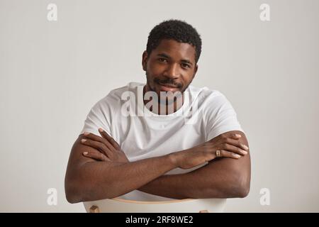 Minimal portrait of handsome black man in studio against white background Stock Photo