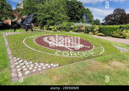 A sculpture called ‘Surrealist Piano’ and a floral display commemorating the coronation, Shrewsbury Castle, Shrewsbury, Shropshire, England, UK Stock Photo