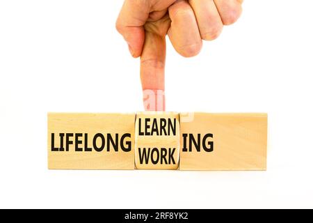 Lifelong learning working symbol. Concept word Lifelong learning working on block on a beautiful white background. Businessman hand. Business, educati Stock Photo