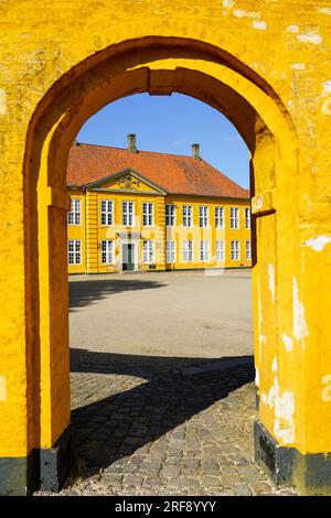 Roskilde, Denmark- May 28, 2023: view through yellow arch to royal palace in Roskilde, built in 1733-36, now a museum of contemporary art Stock Photo