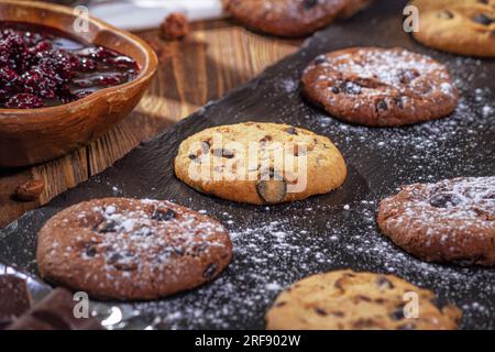 Cookies with chocolate and coffee on a wooden table, selective focus, close up Stock Photo