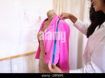 Fashion Designer Lady Using Tape Measuring Garment On Dummy, Cropped Stock Photo