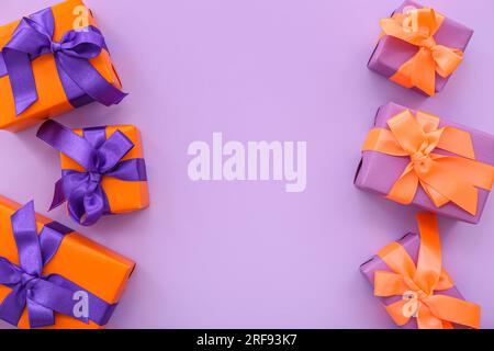 Beautiful gift boxes for Halloween on purple background Stock Photo