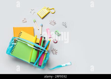 Pencil case with different school stationery on light background Stock Photo