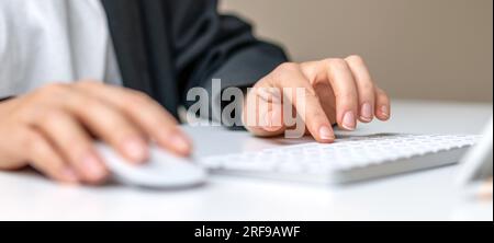 Close-up index finger presses a key computer keyboards, Business person working on the computer, selective focus on finger. Stock Photo