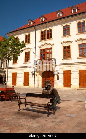 Napolean soldier statue leaning on a bench in the old town of Bratislava in Slovakia in Eastern Europe Stock Photo