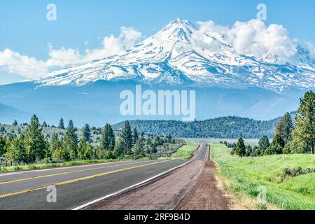 Long road leading towards Mt Shasta in the Cascade mountains in the Klamath National Forest of California Stock Photo